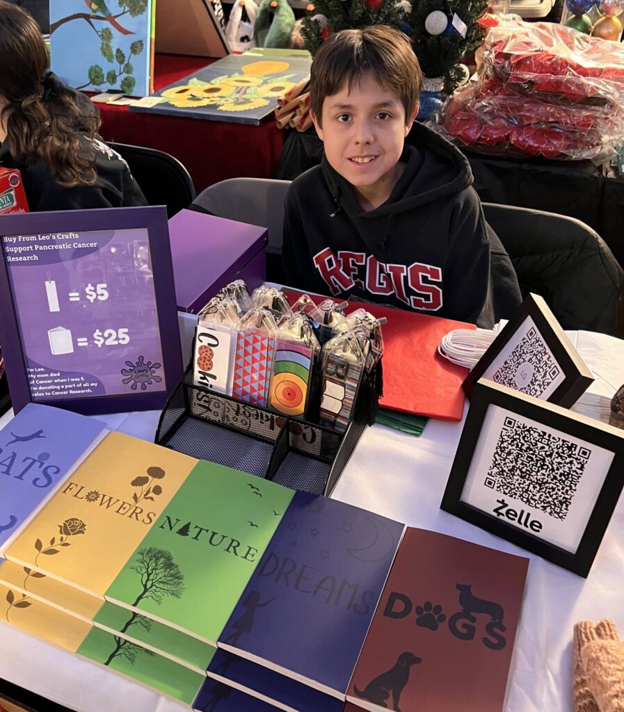 Leo Giancola selling crafts at craft fair.